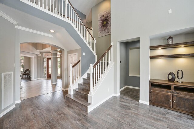 5310 Fairwick Ct, Katy, TX 77450 - entrance foyer with visible vents, decorative columns, wood finished floors, baseboards, and arched walkways