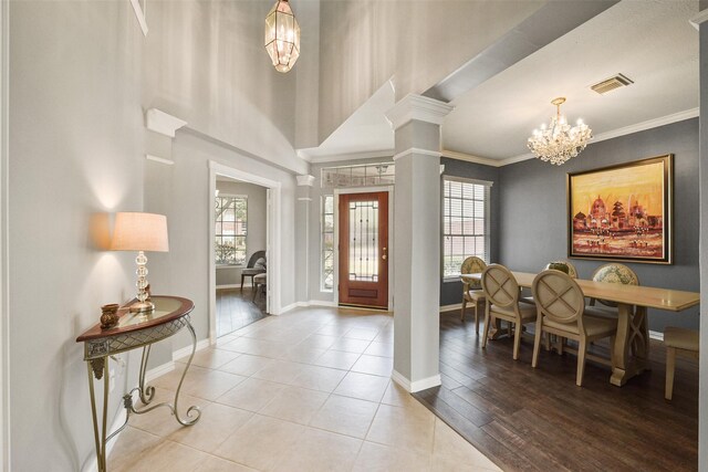 5310 Fairwick Ct, Katy, TX 77450 - tiled foyer entrance featuring visible vents, ornamental molding, decorative columns, baseboards, and a chandelier