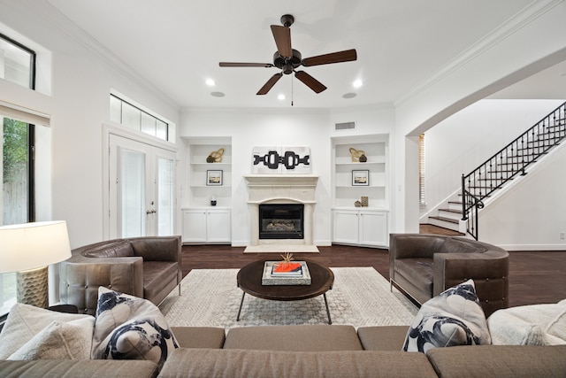 6015 Tyne St, Houston, TX 77007 - living room with dark wood-style floors, visible vents, built in shelves, and ornamental molding