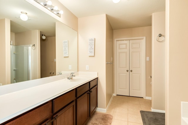 9411 Emerald Green Dr, Rosharon, TX 77583 - bathroom with tile patterned flooring, vanity, baseboards, and walk in shower