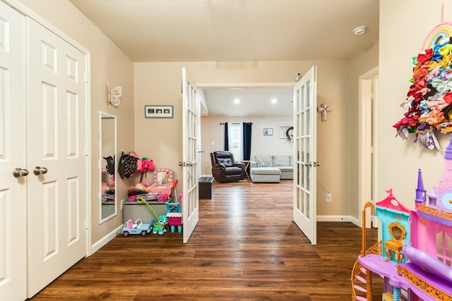 9411 Emerald Green Dr, Rosharon, TX 77583 - game room featuring dark wood-style floors, french doors, and baseboards