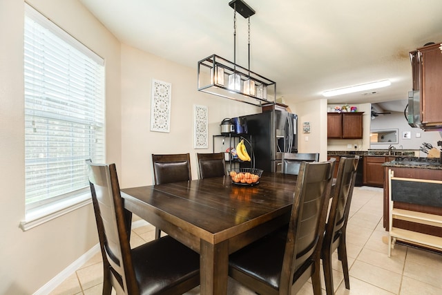 9411 Emerald Green Dr, Rosharon, TX 77583 - dining space with light tile patterned floors, a healthy amount of sunlight, and baseboards