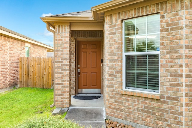 9411 Emerald Green Dr, Rosharon, TX 77583 - doorway to property with a yard, fence, and brick siding