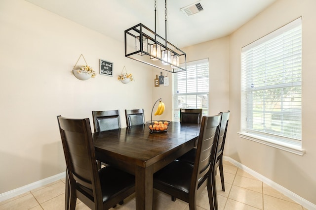 9411 Emerald Green Dr, Rosharon, TX 77583 - dining space with visible vents, baseboards, a healthy amount of sunlight, and light tile patterned flooring