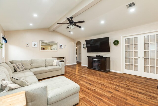 9411 Emerald Green Dr, Rosharon, TX 77583 - living area featuring visible vents, a ceiling fan, wood finished floors, arched walkways, and vaulted ceiling with beams