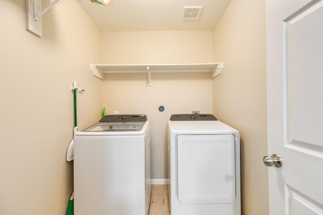 9411 Emerald Green Dr, Rosharon, TX 77583 - laundry area featuring light tile patterned floors, visible vents, laundry area, and washing machine and clothes dryer