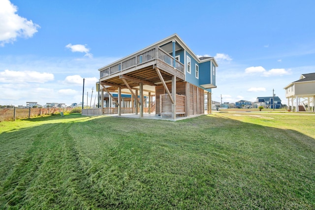 23194 Camino St, Galveston, TX 77554 - rear view of house featuring a deck, a yard, a patio area, fence, and stairway