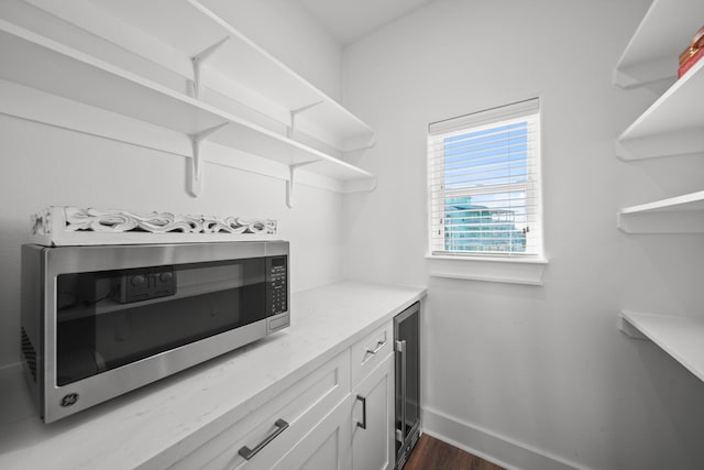 23194 Camino St, Galveston, TX 77554 - walk in closet featuring dark wood-style flooring and wine cooler