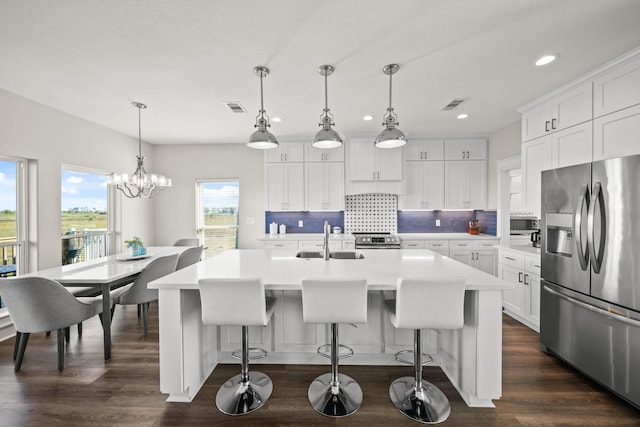 23194 Camino St, Galveston, TX 77554 - kitchen with recessed lighting, light countertops, decorative backsplash, stainless steel appliances, and a sink