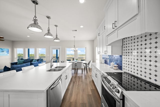 23194 Camino St, Galveston, TX 77554 - kitchen featuring light countertops, appliances with stainless steel finishes, a sink, and visible vents