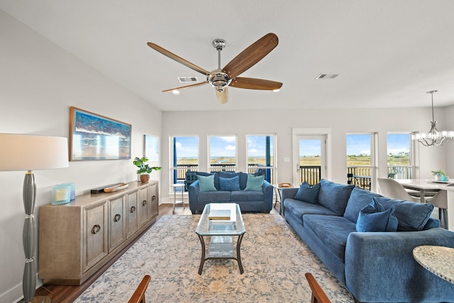 23194 Camino St, Galveston, TX 77554 - living room with ceiling fan with notable chandelier, wood finished floors, and visible vents