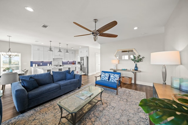 23194 Camino St, Galveston, TX 77554 - living area with ceiling fan with notable chandelier, visible vents, recessed lighting, baseboards, and dark wood-style floors