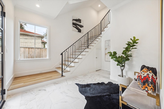 entrance foyer featuring marble finish floor, recessed lighting, and stairway