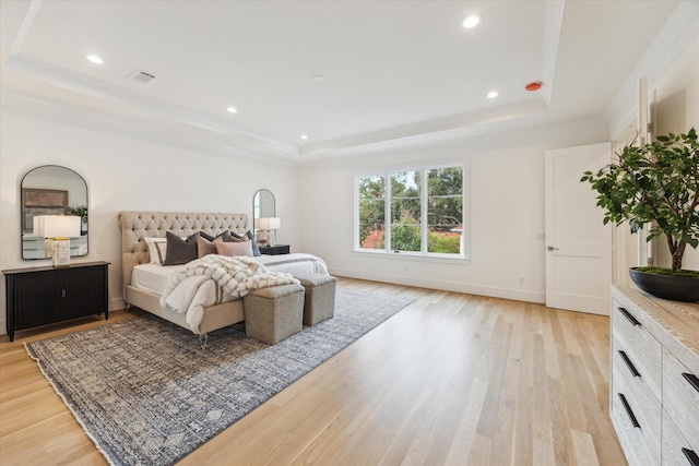 bedroom with visible vents, a tray ceiling, recessed lighting, and light wood-type flooring