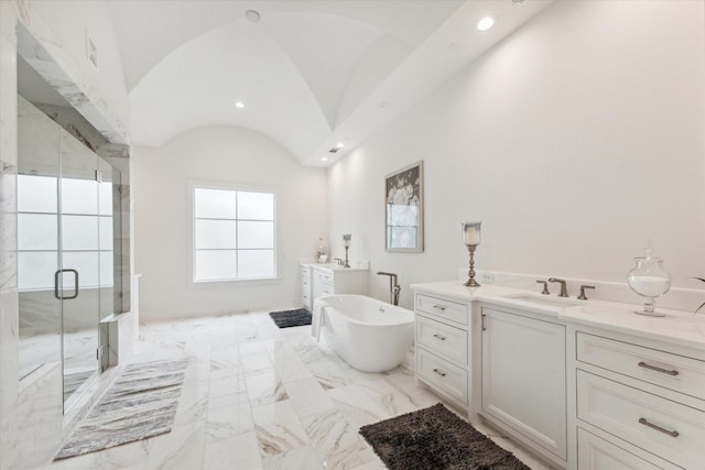 full bath featuring two vanities, a sink, a stall shower, vaulted ceiling, and marble finish floor