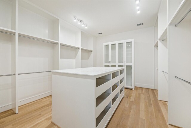 spacious closet featuring light wood-style flooring and visible vents