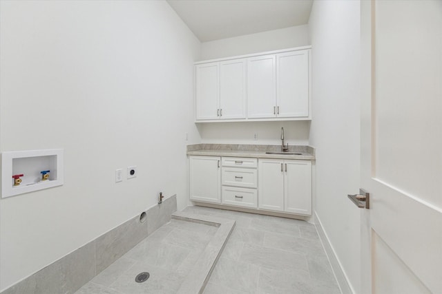 laundry area with a sink, hookup for an electric dryer, hookup for a washing machine, hookup for a gas dryer, and cabinet space