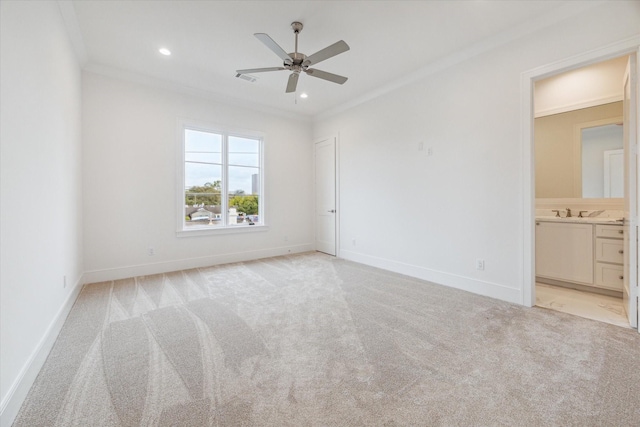 unfurnished bedroom featuring baseboards, crown molding, and light colored carpet