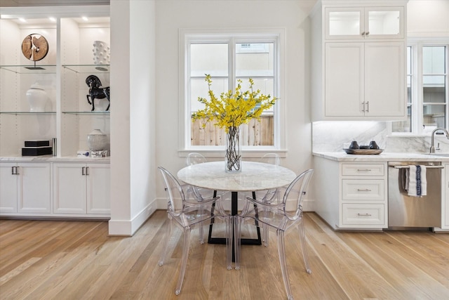 dining area featuring baseboards and light wood-style floors