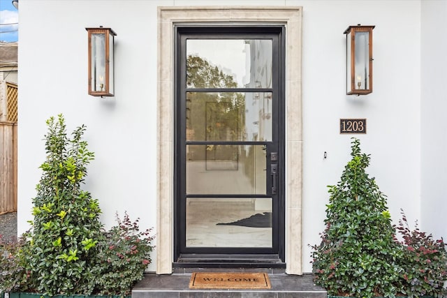 property entrance with stucco siding