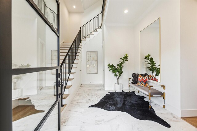 entrance foyer featuring marble finish floor, recessed lighting, and stairway