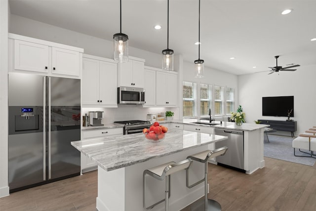 2243 Garden Arbor, Tomball, TX 77375 - kitchen with stainless steel appliances, a sink, a kitchen island, a peninsula, and open floor plan