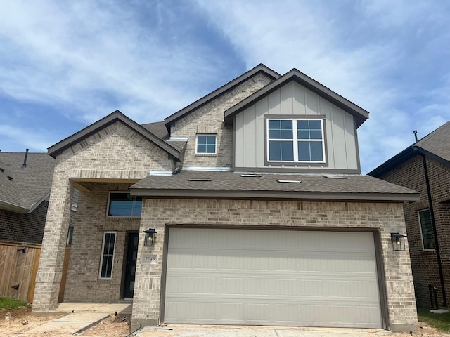 2243 Garden Arbor, Tomball, TX 77375 - view of front of house with a shingled roof, board and batten siding, brick siding, and fence