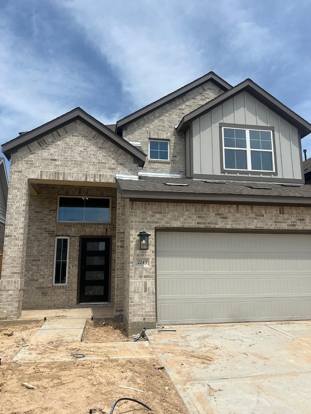 2243 Garden Arbor, Tomball, TX 77375 - view of front of home featuring a garage, brick siding, and driveway