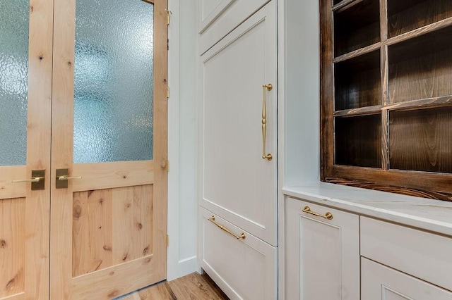doorway with light wood finished floors