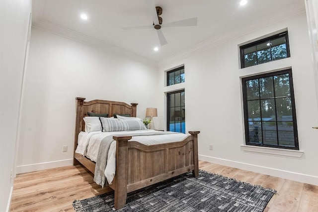 bedroom featuring ornamental molding, baseboards, and wood finished floors