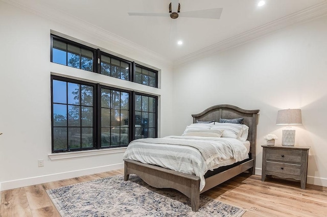 bedroom with wood finished floors, recessed lighting, crown molding, baseboards, and ceiling fan
