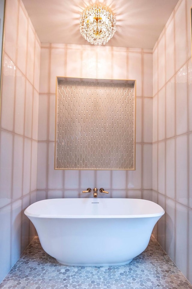 full bath featuring a soaking tub and tile walls