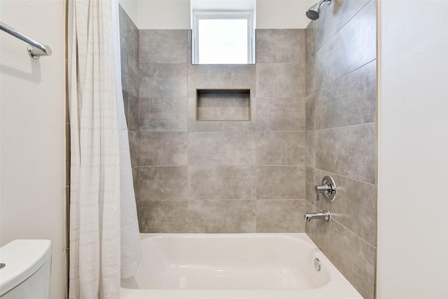 full bathroom featuring toilet and shower / bathtub combination with curtain