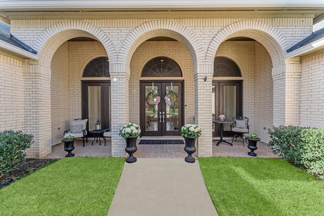 31810 Edgewater Dr, Magnolia, TX 77354 - doorway to property with brick siding, french doors, and a porch