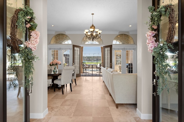 interior space with crown molding, recessed lighting, baseboards, and a notable chandelier