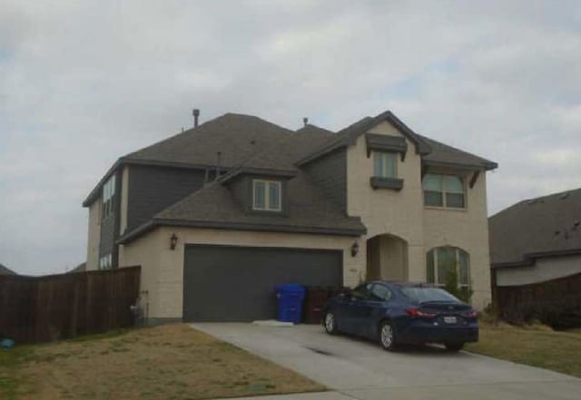 view of front of house featuring a garage and concrete driveway