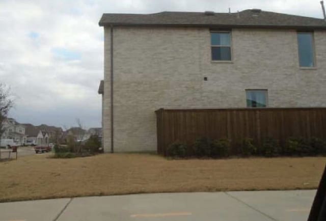 view of side of home with fence