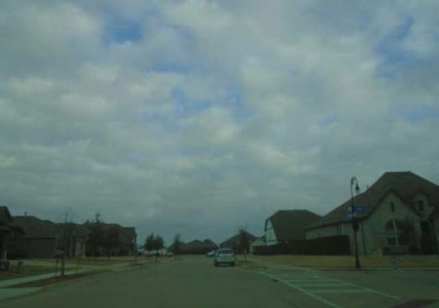 view of road with curbs and sidewalks