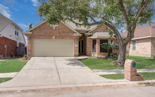 view of front of home with driveway, a front yard, a garage, and brick siding