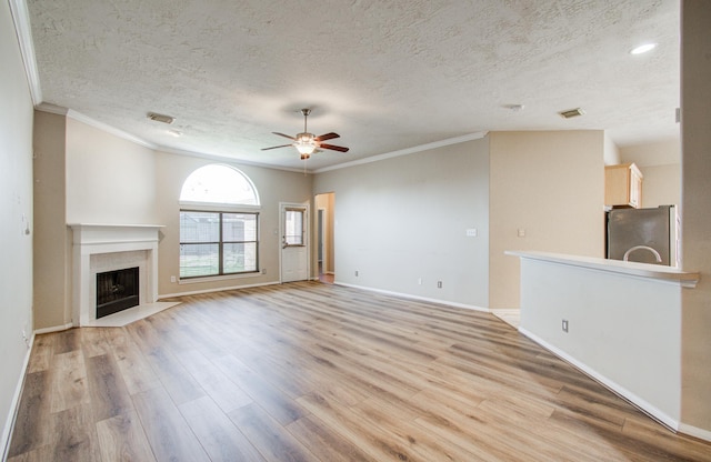 unfurnished living room with visible vents, a ceiling fan, and light wood finished floors