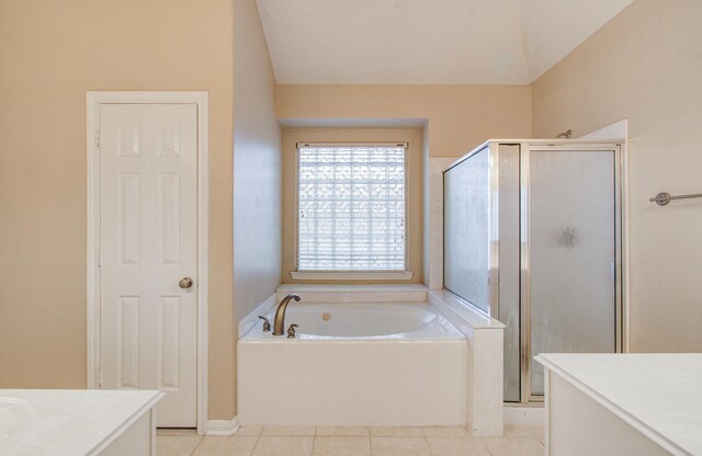 full bath featuring tile patterned flooring, vanity, a stall shower, and a garden tub