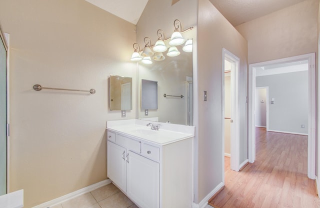 bathroom featuring vanity, baseboards, and wood finished floors
