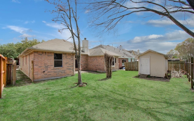 view of yard with a fenced backyard, an outdoor structure, and a shed