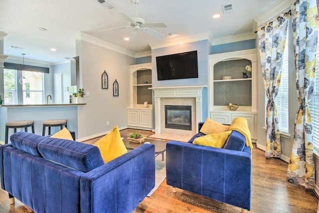 207 Knox St, Houston, TX 77007 - living area with visible vents, baseboards, a fireplace with flush hearth, and wood finished floors