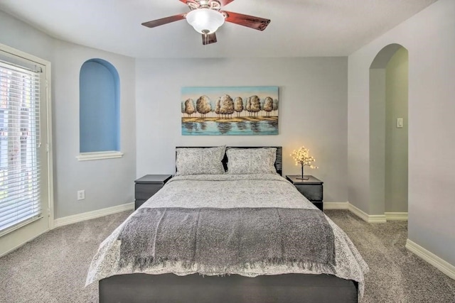 207 Knox St, Houston, TX 77007 - carpeted bedroom featuring a ceiling fan, baseboards, and arched walkways