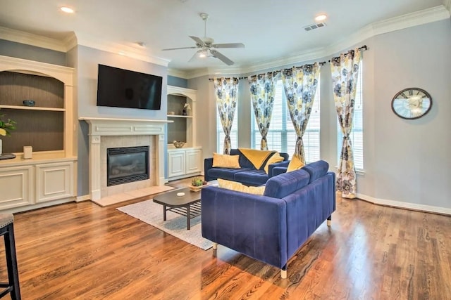 207 Knox St, Houston, TX 77007 - living room featuring visible vents, ceiling fan, ornamental molding, a fireplace, and wood finished floors