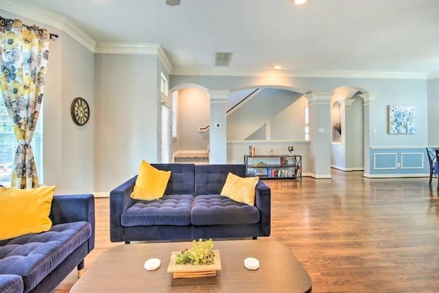 207 Knox St, Houston, TX 77007 - living area with visible vents, crown molding, decorative columns, wood finished floors, and arched walkways