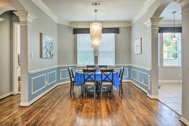 207 Knox St, Houston, TX 77007 - dining room featuring crown molding, visible vents, arched walkways, and ornate columns