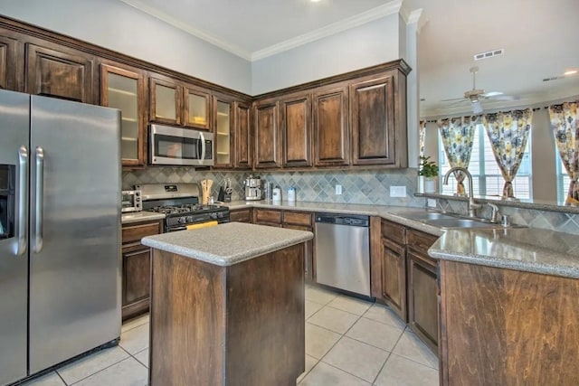 207 Knox St, Houston, TX 77007 - kitchen with visible vents, ornamental molding, a sink, appliances with stainless steel finishes, and light tile patterned floors