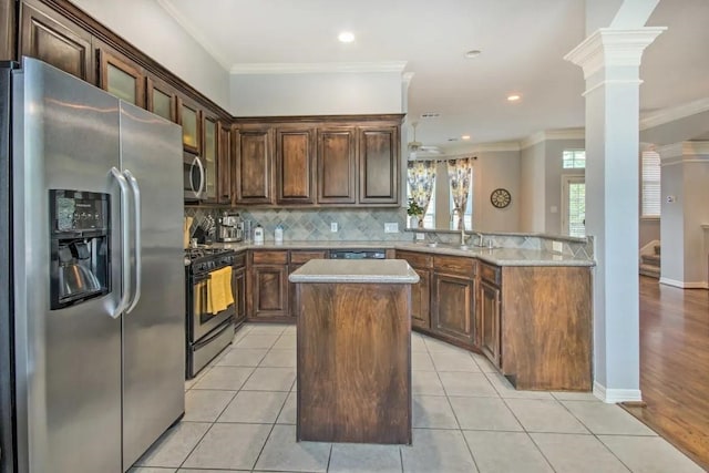 207 Knox St, Houston, TX 77007 - kitchen with light tile patterned floors, decorative backsplash, appliances with stainless steel finishes, and crown molding